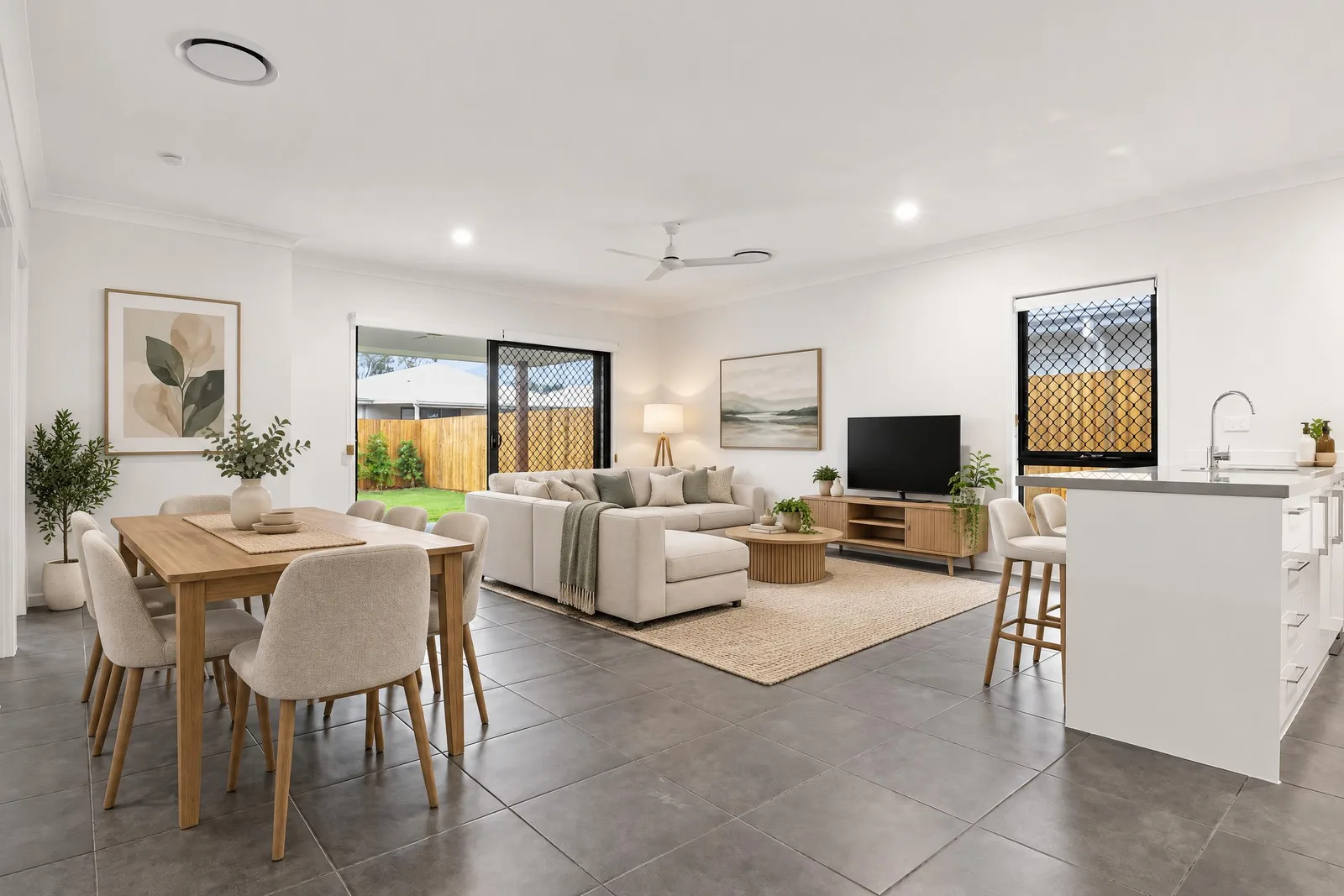 The same open-plan space virtually staged by Spaceora in modern style with a dining set, sofa and rug.
